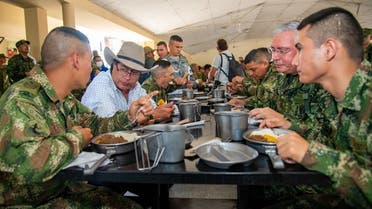 President Gustavo Petro (2-L) speaking with soldiers while having lunch at the Forth Division Army Base in Apiay, department of Meta, Colombia, on August 17, 2022. (Colombian Presidency/AFP)