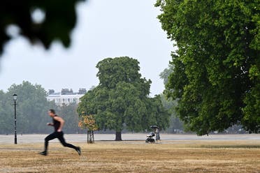 People walk during a heavy downpour on Clapham Common, following a long period of hot weather and little rainfall, in London, Britain, on August 17, 2022. (Reuters)