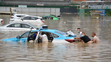 People push a taxi at a flooded electric vehicle (EV) charging station following heavy rainfall in Lanzhou, Gansu province, China July 11, 2022. (File photo: Reuters)