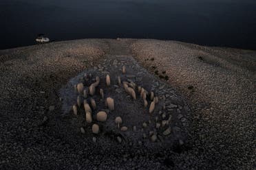 The dolmen of Guadalperal, also known as the Spanish Stonehenge, is seen due to the receding waters of the Valdecanas reservoir in the outskirts of El Gordo, Spain, August 3, 2022. (Reuters) 