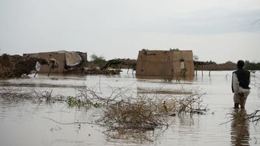 A Sudanese man walks through a flooded area near al-Qash river on August 18, 2022 in Aroma, in the eastern state of Kassala, one of the badly affected regions in Sudan due to torrential rains this week. (AFP)