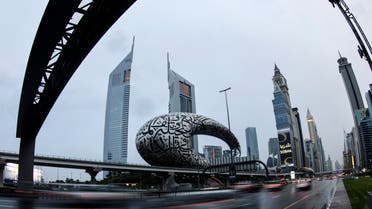 Cars drive past a sculpture covered with Arabic calligraphy along the Sheikh Zayed road in the Gulf emirate of Dubai, on January 1, 2022. (AFP)