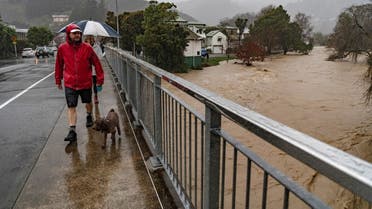 Residents cross a bridge over the Maitai River as severe flooding affects Nelson, New Zealand, August 18, 2022. (Reuters)