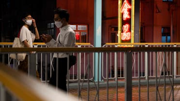 People walk past a neon light sign at a footbridge in Hong Kong’s Mong Kok area on August 20, 2022. (File photo: AFP)