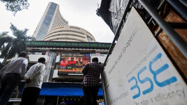 People stand outside the Bombay Stock Exchange (BSE), after Sensex surpassed the 60,000 level for the first time, in Mumbai, India, on September 24, 2021. (Reuters)