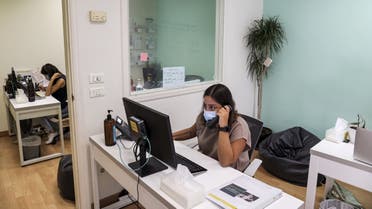 Magalie Eid, a volunteer operator, answers calls at Embrace, an NGO which runs a suicide-prevention hotline, in Lebanon's capital Beirut on September 1, 2021. (File photo: Reuters)