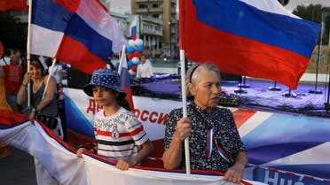 Russians living in Cyprus hold their national flags to celebrate Russia Day in Nicosia, Cyprus, on June 12, 2022. (Reuters)