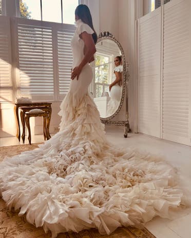 Jennifer Lopez wearing one of her three Ralph Lauren wedding dresses. (Supplied)