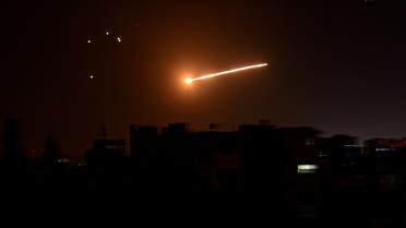 FILE PHOTO: A streak of light is seen in the night sky in the vicinity of the Syrian capital Damascus during what Syrian authorities said was an Israeli air strike, in this handout released by state news agency SANA on February 24, 2020. SANA/Handout via REUTERS ATTENTION EDITORS - THIS IMAGE WAS PROVIDED BY A THIRD PARTY. REUTERS IS UNABLE TO INDEPENDENTLY VERIFY THIS IMAGE/File Photo