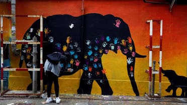 A participant makes a hand print during a campaign to raise awareness on illegal wildlife trade, in Hong Kong, China. (File photo: Reuters)