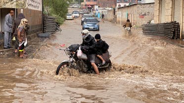 People ride a motorbike as they cross a flooded street during heavy rains in Sanaa, Yemen August 1, 2022. REUTERS/Khaled Abdullah