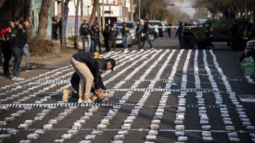 Police officers organise seized packages of cocaine during a press conference in Rosario, Santa Fe province, Argentina on August 26, 2022. (AFP)