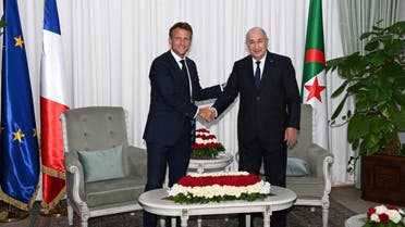 French President Emmanuel Macron shakes hand with Algerian President Abdelmadjid Tebboune, at the presidential palace in Algiers, Algeria August 25, 2022. (Reuters)