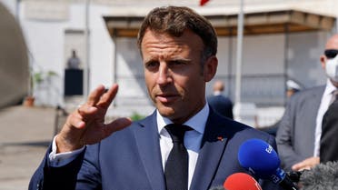 French President Emmanuel Macron speaks to the press after visiting the European Saint-Eugene Cemetery in Algiers on August 26, 2022. (AFP)
