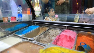Palestinian girl eats ice cream in Kathem ice cream shop, as heat and lengthy power cuts melt ice cream shops' profits, in Gaza City August 24, 2022. (Reuters)