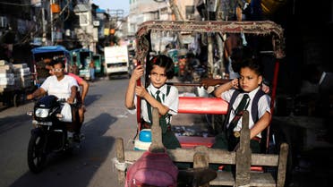 School children sit in a cycle rickshaw as they wait for the rickshaw-puller during the morning in the old quarters of Delhi August 27, 2014. (File photo: Reuters)