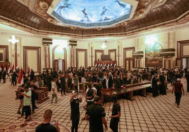 Supporters of Iraqi Shia cleric Moqtada Sadr gather inside the Republican Palace in the capital Baghdad's Green Zone, on August 29, 2022. (AFP)