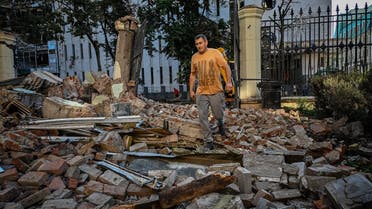 A municipal service worker walks through the rubble of a destroyed building following an overnight missile strike in Kharkiv, on August 29, 2022, amid Russia’s military invasion launched on Ukraine. (AFP)