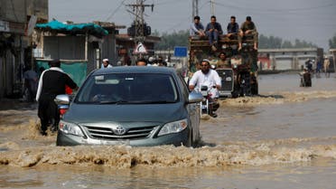 Vehicles move amid flood water along a road, following rains and floods during the monsoon season in Nowshera, Pakistan August 30, 2022. (Reuters)