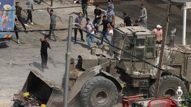 Palestinians hurl rocks at Israeli army vehicles during clashes in the town of Rujayb, east of the occupied West Bank city of Nablus on August 30, 2022, after Palestinians opened fire at Israelis who snuck into the city. (AFP)