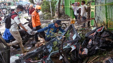 Rescuers work on the site of an accident that claimed nearly a dozen lives including school children and dozens were injured, in Bekasi on August 31, 2022, after a truck (L behind) rammed into people, street vendors and a cellular antenna tower that toppled over. (AFP)
