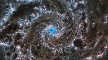 This image from the NASA/ESA/CSA James Webb Space Telescope shows the heart of M74, otherwise known as the Phantom Galaxy. Webb’s sharp vision has revealed delicate filaments of gas and dust in the grandiose spiral arms which wind outwards from the centre of this image. A lack of gas in the nuclear region also provides an unobscured view of the nuclear star cluster at the galaxy's centre.