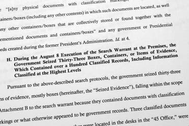 Pages from a Department of Justice court filing on Aug. 30, 2022, in response to a request from the legal team of former President Donald Trump for a special master to review the documents seized during the Aug. 8 search of Mar-a-Lago, are photographed early Wednesday, Aug. 31, 2022. (AP Photo/Jon Elswick)