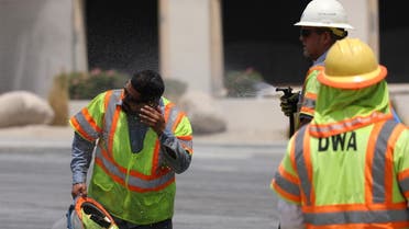 A Desert Water Agency worker sprays a co-worker in temperatures that have reached well above triple digits in Palm Springs, California, U.S. July 20, 2022. (Reuters)