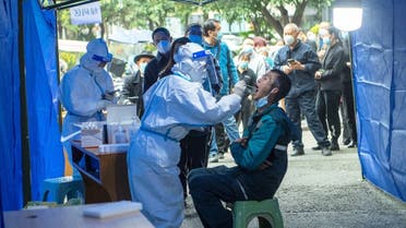 People line up at a makeshift nucleic acid testing site near a residential compound under lockdown following local cases of the coronavirus in Chengdu, Sichuan province, China. (Reuters)