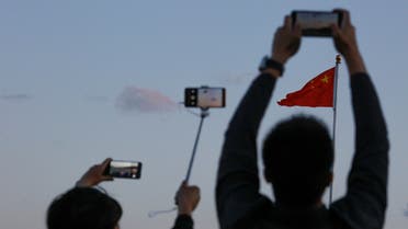 People take pictures of the lowering ceremony of the Chinese national flag that is held daily at sunset in Tiananmen Square in Beijing, China May 19, 2019. (File photo: Reuters)