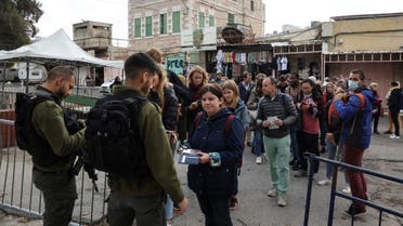 Israeli border police check the passports of French tourists on their way to visit the Muslim area of the divided Ibrahimi Mosque or the Tomb of the Patriarchs in the occupied West Bank town of Hebron, on November 20,2021. (File photo: Reuters)