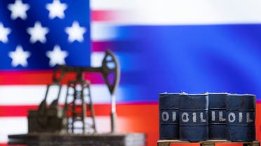 Models of oil barrels and a pump jack are seen in front of displayed U.S. and Russia flag colours in this illustration taken March 8, 2022. (Reuters)