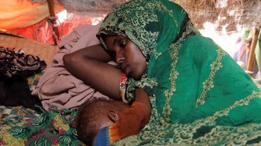 bdia Aden Mohamed rests with her 8-month-old child Ayan Hassan inside their makeshift shelter at the Kaxareey camp for the internally displaced people in Dollow, Gedo region of Somalia on May 24, 2022. (Reuters)