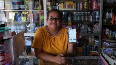 Gloria Barcia shows her Bitcoin wallet at her store in the town of Conchagua, near the projected site for the Bitcoin City according to El Salvador's President Nayib Bukele, in Conchagua, El Salvador August 19, 2022. (Reuters)