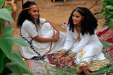 Ethiopian Reem Suhail and Yudita Ihab(R), wearing headbands in the colors of Tigray’s flag, take part in the Ashenda celebrations at al-Qurashi park in the Sudanese capital Khartoum, on August 26, 2022. (AFP)