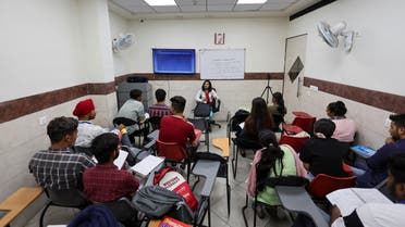 Students attend an International English Language Testing System (IELTS) class conducted by Western Overseas, an institute providing coaching for English language proficiency tests and visa consultancy, in Ambala, India, August 4, 2022. (Reuters)