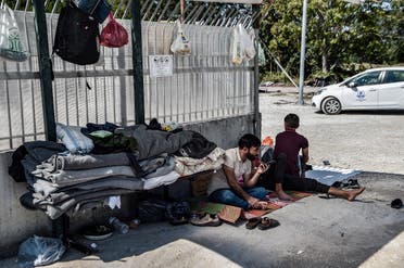 Yazidi migrants from Iraq wait for the entry into a refugee camp in Serres, northern Greece, as they have been stranded outside the camps in Serres for nearly two weeks, September 6, 2022. (AFP)