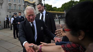 Britain’s King Charles III greets the members of the public in the crowd upon his arrival at Buckingham Palace in London, on September 9, 2022, a day after Queen Elizabeth II died at the age of 96. (AFP)