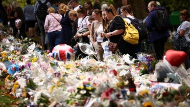 People visit floral tributes placed in Green Park near Buckingham Palace, following the passing of Britain's Queen Elizabeth, in London, Britain, September 10, 2022. REUTERS/Henry Nicholls