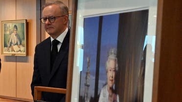 Prime Minister Anthony Albanese stands near an image of Queen Elizabeth II following her death, after signing the condolence book at Parliament House in Canberra, Australia, on September 9, 2022. (Reuters)