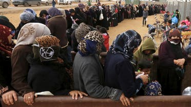 Syrian refugees stand in line as they wait for aid packages at Al Zaatari refugee camp in the Jordanian city of Mafraq, near the border with Syria, January 20, 2016. REUTERS/ Muhammad Hamed