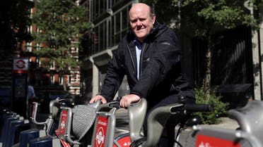 Rupert Soames, CEO of Serco Group Plc, poses for a photograph on a London rental bike outside their offices in London, Britain. (Reuters)