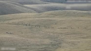 A still image from video, released by the Armenian Defence Ministry, shows what it said to be Azerbaijani service members moving along an unidentified mountainous border area with Armenia, in this still image taken from handout footage released September 13, 2022. (Reuters)