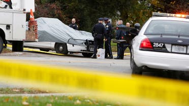 Police officers cover a squad car at the scene of a police shooting in Des Moines, Iowa, where one of two police officers were shot and killed in separate attacks described as ambush-style in Urbandale and Des Moines, Iowa, U.S., November 2, 2016. 