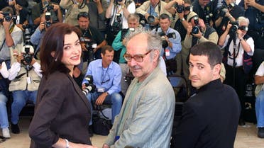 In this file photo taken on May 15, 2001 (From L) French actress Cecile Camp, Franco-Swiss director Jean-Luc Godard and French actor Bruno Putzulu pose at the Palais des Festivals during the photocall of “L’Eloge de l’Amour” in Cannes. (AFP)
