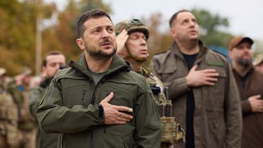 Ukraine's President Zelenskiy sings a national anthem during a flag rising ceremony in the town of Izium recently liberated by the Ukrainian Armed Forces during a counteroffensive operation, amid Russia's attack on Ukraine, in Kharkiv region,Ukraine September 14, 2022. Ukrainian Presidential Press Service/Handout via REUTERS ATTENTION EDITORS - THIS IMAGE HAS BEEN SUPPLIED BY A THIRD PARTY.