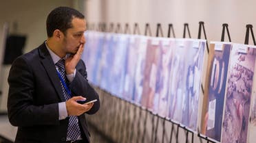 A man reacts as he looks at a gruesome collection of images of dead bodies taken by a photographer, who has been identified by the code name Caesar, at the United Nations Headquarters in New York, March 10, 2015. (File photo: Reuters)
