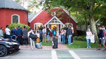Venezuelan migrants stand outside St. Andrew's Church in Edgartown, Massachusetts, US September 14, 2022. (Reuters)