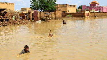 Sudanese children swim in flood water in the town of Iboud, in al-Gezira state, 250kms south of the capital Khartoum, on August 22, 2022. (AFP)