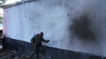 A man stands next to a building damaged by recent shelling during border clashes with Azerbaijan, in the town of Jermuk, Armenia, on September 15, 2022. (Reuters)
